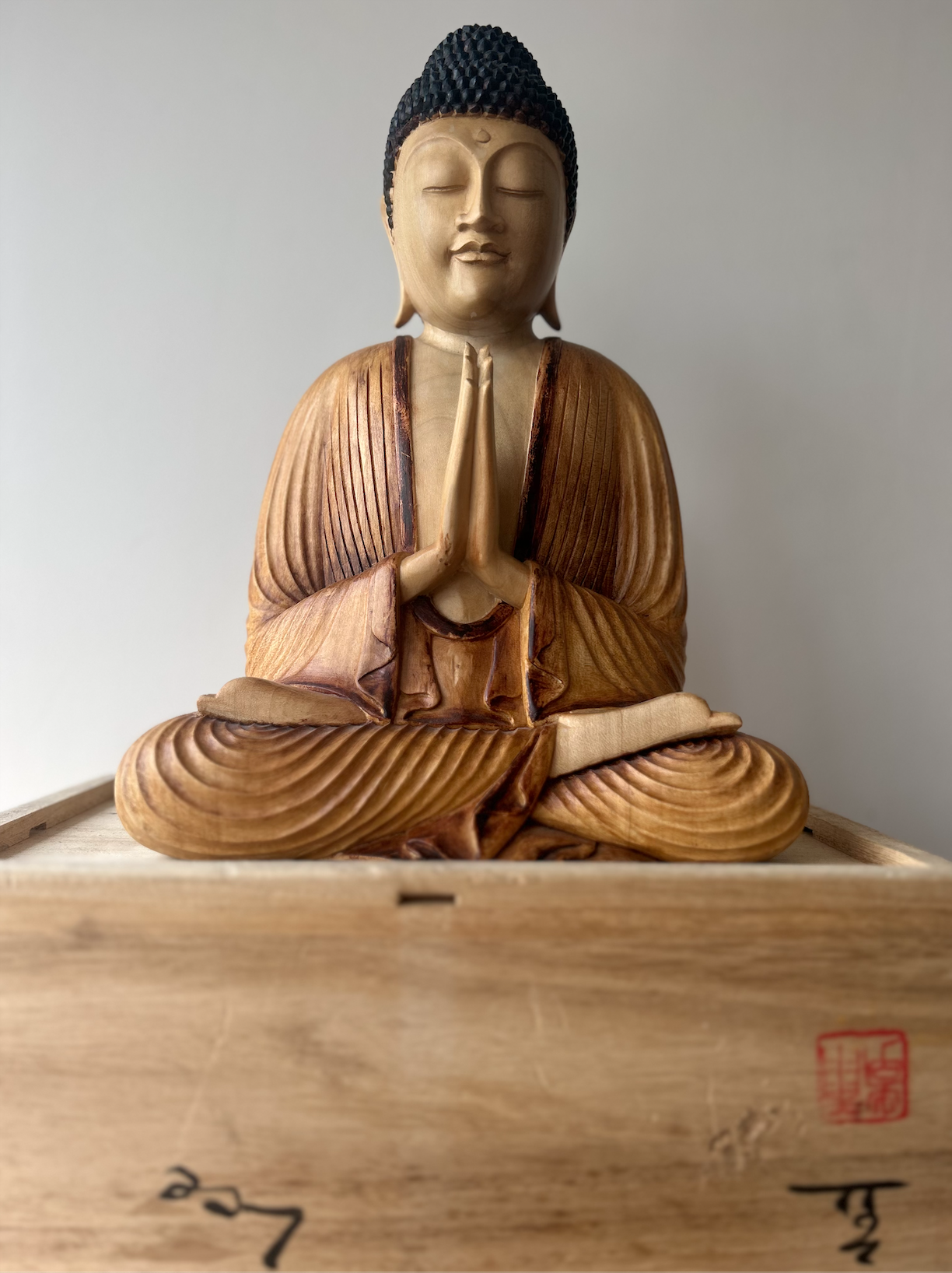 This statue of the Buddha was purchased for the Pharmacy studio and to accompany the members of the Opening Heart Mindfulness Community in their practice. It is of Korean origin. This statue depicts the Buddha with his hands pressed together in anjali mudra. This mudra has been widely used in Asian art and religious artifacts for centuries and connotes respect, greeting, and divine offering.